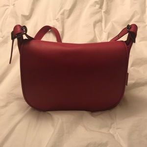 Brand new Coach saddle bag in Cerise pink .